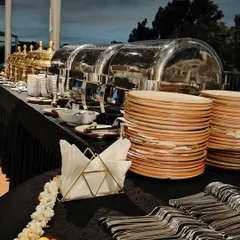 A traditional buffet setup for a mesmerizing Arangetram event. Our elegant chafing dishes, stacked plates, and professional arrangement ensure a seamless dining experience for your guests.
