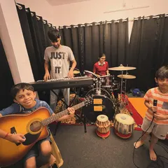 Our students getting ready for their monthly jam session. You can see the excitement and focus as they set up their instruments, from guitar and keyboard to drums and vocals.