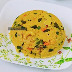 This is our Khara Bath, a savory semolina dish cooked with mixed vegetables, spices, and topped with cashews. It's a comforting and wholesome breakfast item that is a staple in South Indian cuisine.