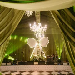 Inspired by a love for modern romance, we designed "The Big Bow Affair." This stage, with its grand illuminated bow and cascading florals under crystal chandeliers, set the scene for a magical evening of celebration. It’s about taking a simple idea and turning it into a breathtaking reality.