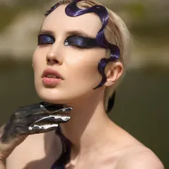 A beauty shot focusing on the Siren's face, highlighting the single rhinestone accent and the black and white paint on the hand.
