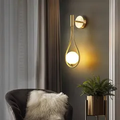 I designed this wall light to feel like a drop of light. The single opal sphere is cradled in a teardrop-shaped golden frame, creating a soft, celestial glow. It's a simple yet elegant addition to a cozy corner or hallway.