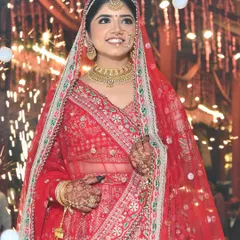 A candid moment of pure happiness. Bhawna looked absolutely radiant for her wedding, with her natural bridal makeup glowing under the lights and sparklers.