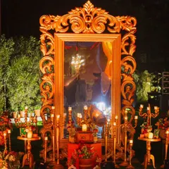 This photo corner is designed for pure elegance. A grand, ornate gold mirror reflects the warm glow of dozens of candles, creating a romantic and dramatic spot for guests to capture beautiful moments.