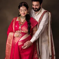 A beautiful moment between the parents-to-be. The makeup is soft and radiant, celebrating this special time.