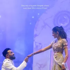 A fairytale moment on stage. The groom's romantic gesture is enhanced by a dreamy, star-lit backdrop and soft, ethereal lighting, a signature of my Sangeet design philosophy.