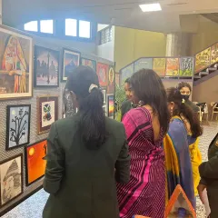 Students and guests admiring the gallery wall at an art exhibition we participated in. Seeing their work professionally framed and displayed is a huge confidence booster for any artist.