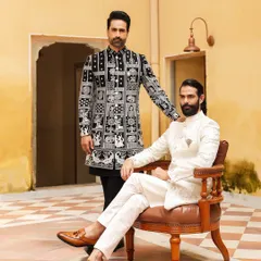 We cater to every style, from timeless tradition to modern elegance. This image captures that duality perfectly, featuring a classic off-white embroidered sherwani alongside a contemporary black and white Indo-Western piece with unique block print designs.