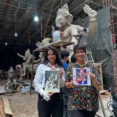 Me and a fellow artist proudly showing our work at the Ganpati idol workshop. The background shows the raw, beautiful chaos of the workspace, where these magnificent idols are born.