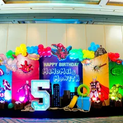 Your child's favorite heroes, brought to life. This vibrant Superhero-themed stage setup for a 5th birthday is a great example of our detailed, multi-character backdrops, complete with custom lighting and props that make for epic photos.