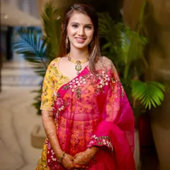 Wrapped in sunshine and florals. This vibrant yellow and pink lehenga is paired with soft glam makeup and dreamy waves for a perfect Mehendi look.