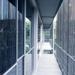 The completed facade of ICP Brunton Central, an adaptive reuse project in Bengaluru. The new skin of perforated metal screens provides shade and a modern identity while allowing the original structure to remain, significantly reducing the environmental impact of the renovation.