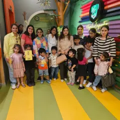 A happy mommy group poses with their little ones. Our indoor space is perfect for parents to socialize while their kids play safely.