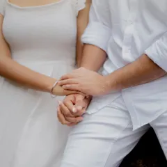 Another beautiful shot of the couple's hands, focusing on their gentle and intimate connection.