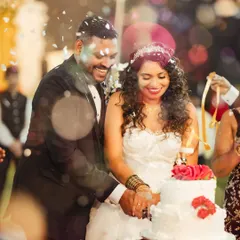 The joyful cake cutting ceremony, complete with a shower of confetti. This photo captures the happiness and celebration of one of the reception's key moments.