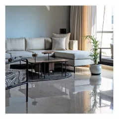 An airy living room from our Powai House project, where light is the primary material. The polished marble floor reflects the open sky, making the entire space feel bright and expansive. We used a clean-lined L-shaped sofa and a simple indoor swing to maintain an uncluttered, serene atmosphere perfect for a city home.