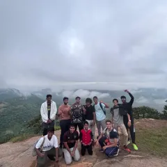An energetic group of college students celebrating at the top of Kabbaldurga. Our college treks are all about building camaraderie and leadership skills through shared challenges.