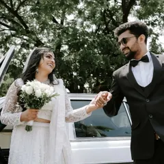 A happy Christian couple making their grand exit, with the groom helping his bride out of the car. It's these small, chivalrous moments that tell a big story.