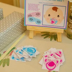 A fun and simple game for all ages: 'Pin the Pacifier on the Baby'. I set up this station with custom-printed game boards and pacifier cutouts, making it an easy and interactive part of the celebration.