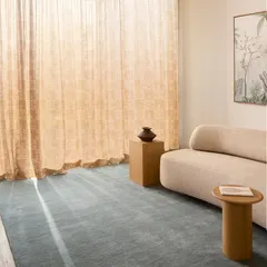 Our custom-designed sheer curtains add an ethereal glow to this living space. The delicate, all-over pattern filters the sunlight beautifully, casting a warm and gentle light that enhances the room's tranquil atmosphere.