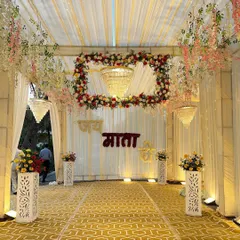 The entrance to the Jagran venue, featuring a stunning photo wall with 'Jai Mata Di' in Hindi. We framed it with a floral arch and chandeliers to create a divine first impression.