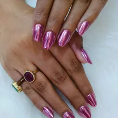 A flawless metallic pink chrome set. The high-shine, mirror-like finish on these almond-shaped nails is bold, glamorous, and guaranteed to turn heads.