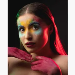 A closer crop from the color powder shoot, emphasizing the model's intense gaze and the texture of the makeup.