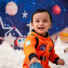 To the moon and back! My studio is equipped for imaginative adventures, like this astronaut theme. I provide all the props and costumes to bring your child's biggest dreams to life in a creative photoshoot.