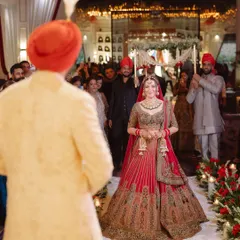 The bride's emotional and beautiful entrance, as she walks towards the groom who is waiting for her at the mandap. A truly timeless wedding moment.