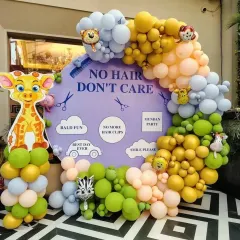 Mundan ceremonies can be fun and quirky. This "No Hair Don't Care" backdrop with a colorful balloon garland and jungle animal cutouts is a popular and playful option I offer for the big haircut day.