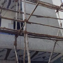 For large exterior projects, we use proper scaffolding to safely and effectively access all areas of the building. This image shows the initial preparation phase of an exterior commercial painting job.