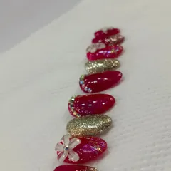 A set of luxurious, handcrafted press-on nails. I teach how to design and create these, featuring 3D flowers, glitter, and rhinestones, offering a great service for clients who want temporary but glamorous nails.