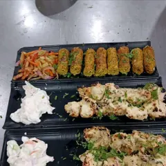 A platter of our freshly prepared appetizers, featuring succulent chicken malai tikka and flavorful vegetable seekh kebabs. This is an example of the quality and presentation we bring to every corporate meal or event.