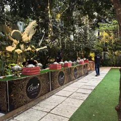 This is our standard buffet setup, nestled in the lush greenery of our venue. We ensure our catering counters are professionally branded and seamlessly integrated into the event space.
