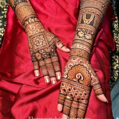 This bridal design features a contrast of styles, with a geometric pattern on one hand and a more traditional peacock and floral design on the other.