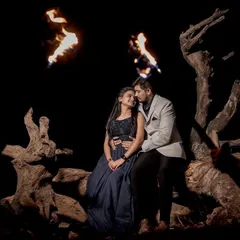 A wide shot of the couple sitting together at night, surrounded by fire. This creates a very dramatic and powerful pre-wedding scene.