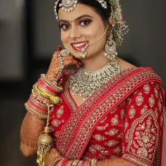 A happy bride is the most beautiful bride. I created this classic North Indian bridal look with shimmering pink eyeshadow and a matching lip color to complement her diamond jewelry.