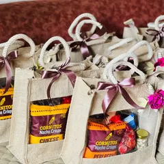 A batch of jute bags with a clear window to see the snacks inside. These are great for casual corporate gifting for employees.