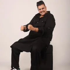 A playful moment during a photoshoot. Even when I'm sitting down, the energy is always on. Dressed in a stylish black kurta, I'm ready to get the party started.