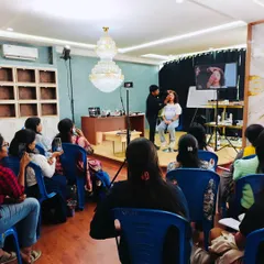 This image shows the full classroom setup, including the lighting, stage, and seating arrangement. I ensure the environment is professional and conducive to learning, allowing every student to feel like they are getting a front-row seat.