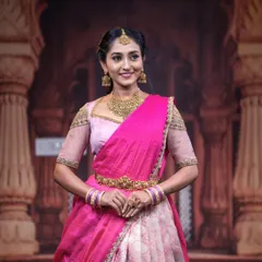 A full view of the pink half saree look, showcasing how our simple yet elegant vaddanam (waist belt) and bangles complete the traditional ensemble.