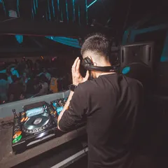 A view from behind me, showing my perspective as I look out onto the crowd while cueing up the next track in my headphones.