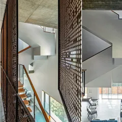The multi-story interior of J-House is connected by a network of voids and staircases, with perforated screens allowing light and air to flow vertically through the home.