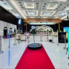 Here is my complete VIP setup in a grand wedding hall. I provide the red carpet, professional lighting, and safety stanchions to create a dedicated, high-energy zone that becomes the center of attention at any event.