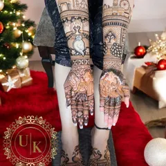 A full view of a bride's hands and feet mehandi. The foot design features elegant peacocks that match the theme of her hand mehandi.