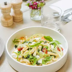 A fresh and vibrant summer pasta dish with seasonal vegetables, feta cheese, and arugula. Our plated courses are designed to be light, flavorful, and beautiful, using the best produce of the season.