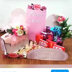 This elegant Rakhi gift set is specially designed for your brother and sister-in-law. It includes a stylish handbag for your bhabhi, a selection of premium chocolates, and beautiful floral arrangements, all presented in a coordinated pink theme.