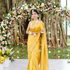 The beautiful bride at her Haldi ceremony, perfectly framed by the floral arch we designed. The decor was created to complement the natural surroundings and her elegant yellow saree.