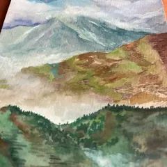 A dreamy watercolor landscape of mountains shrouded in mist. The layers of green and brown hills fading into the clouds create a sense of depth and tranquility. This piece is about getting lost in daydreams of distant lands.