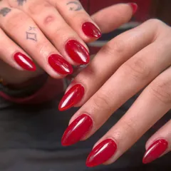 You can never go wrong with a classic red. This is a vibrant, glossy red gel polish on beautifully shaped almond nails. It's a powerful and confident look for any occasion.